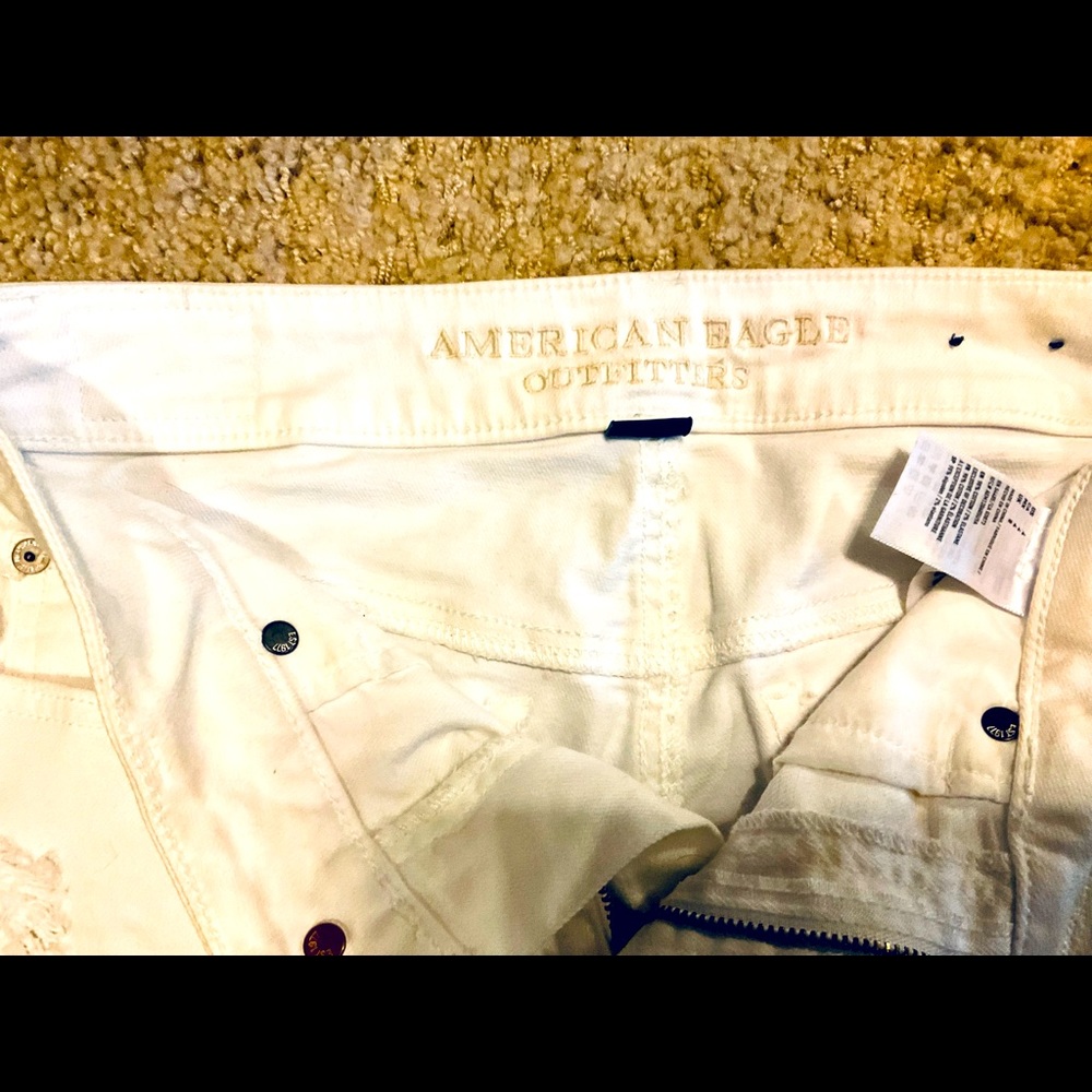 Distressed white denim shorts
